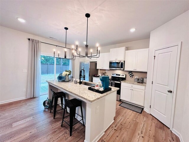 135 Softwood Ct, Dawsonville, GA 30534 - kitchen featuring stainless steel appliances, a chandelier, light wood-type flooring, and recessed lighting