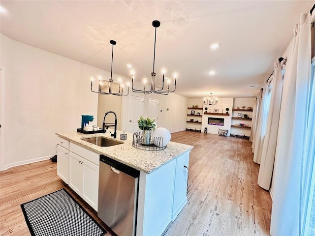 135 Softwood Ct, Dawsonville, GA 30534 - kitchen featuring dishwasher, a chandelier, light wood finished floors, an island with sink, and white cabinets