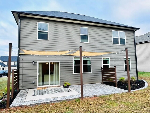 135 Softwood Ct, Dawsonville, GA 30534 - back of property featuring a patio and a lawn