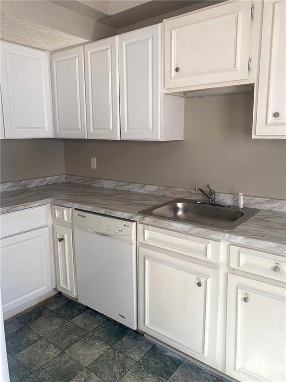 kitchen featuring sink, white cabinetry, dishwasher, and dark tile patterned flooring