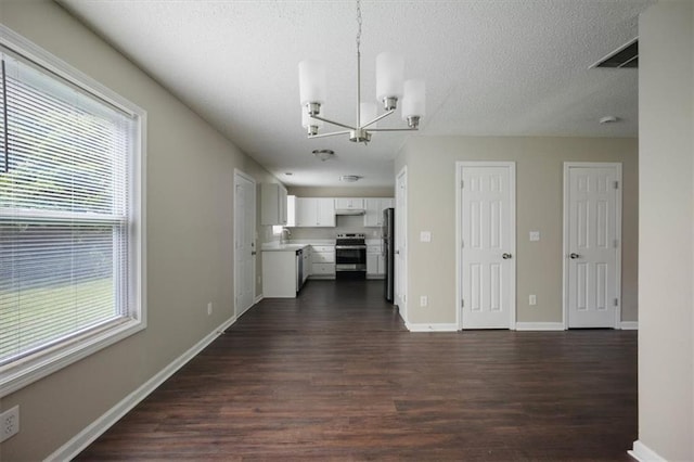 3915 Cypress Pointe Dr, Union City, GA 30291 - unfurnished living room featuring a chandelier, dark wood-style floors, a sink, a textured ceiling, and baseboards