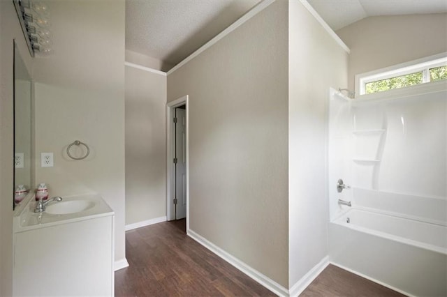 3915 Cypress Pointe Dr, Union City, GA 30291 - bathroom with vanity, shower / bath combination, wood finished floors, vaulted ceiling, and baseboards