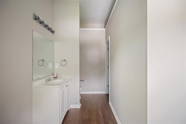 3915 Cypress Pointe Dr, Union City, GA 30291 - half bathroom with toilet, vanity, wood finished floors, baseboards, and a textured ceiling