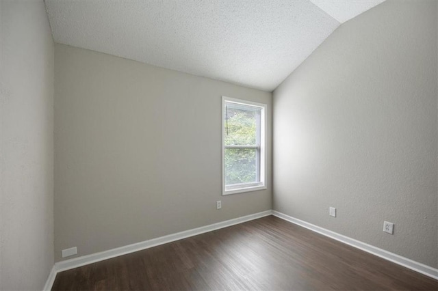 3915 Cypress Pointe Dr, Union City, GA 30291 - empty room with dark wood-style flooring, vaulted ceiling, baseboards, and a textured ceiling