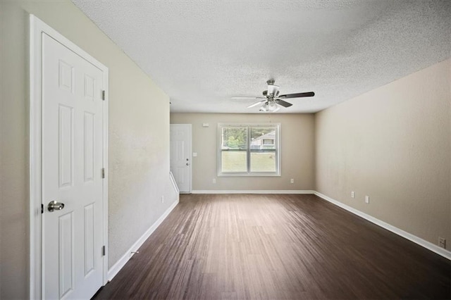 3915 Cypress Pointe Dr, Union City, GA 30291 - spare room featuring dark wood-style floors, a ceiling fan, a textured ceiling, and baseboards