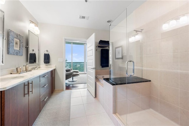 bathroom with tile patterned flooring, an enclosed shower, and vanity