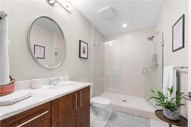 bathroom featuring an enclosed shower, vanity, tile patterned floors, and toilet