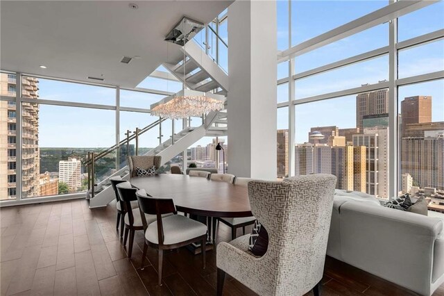 45 Ivan Allen Jr Blvd NW Unit 2705, Atlanta, GA 30308 - dining room featuring a wall of windows, plenty of natural light, dark wood-type flooring, a city view, and a towering ceiling