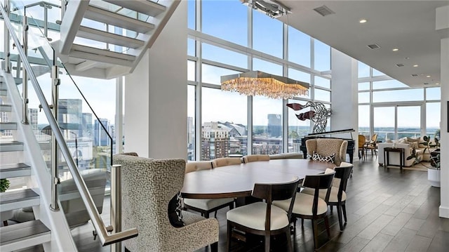 45 Ivan Allen Jr Blvd NW Unit 2705, Atlanta, GA 30308 - dining room with expansive windows, stairs, a towering ceiling, dark wood-type flooring, and a city view
