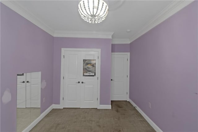 1786 Dekalb Ave NE, Atlanta, GA 30307 - unfurnished bedroom featuring a chandelier, crown molding, baseboards, carpet, and a closet