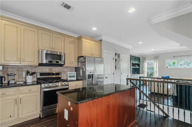 1786 Dekalb Ave NE, Atlanta, GA 30307 - kitchen with stainless steel appliances, cream cabinets, crown molding, dark wood-style flooring, and decorative backsplash