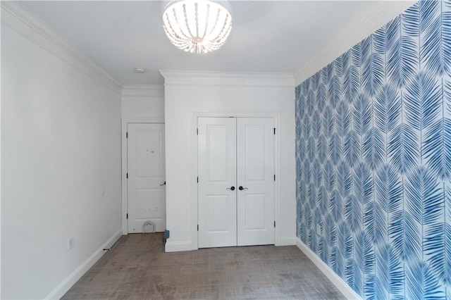 1786 Dekalb Ave NE, Atlanta, GA 30307 - unfurnished bedroom featuring crown molding, carpet flooring, baseboards, a chandelier, and a closet