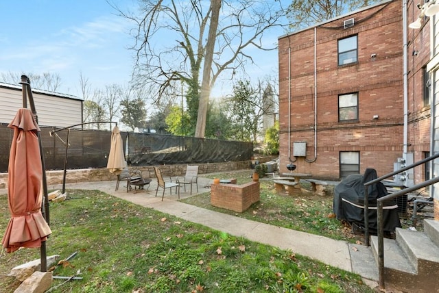 view of yard featuring a trampoline and a patio area