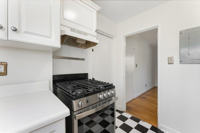 kitchen featuring white cabinetry, electric panel, and stainless steel gas range