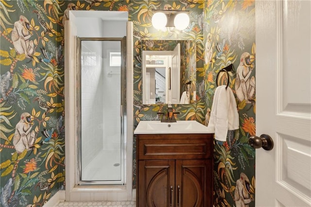 bathroom featuring tile patterned flooring, vanity, and a shower with door