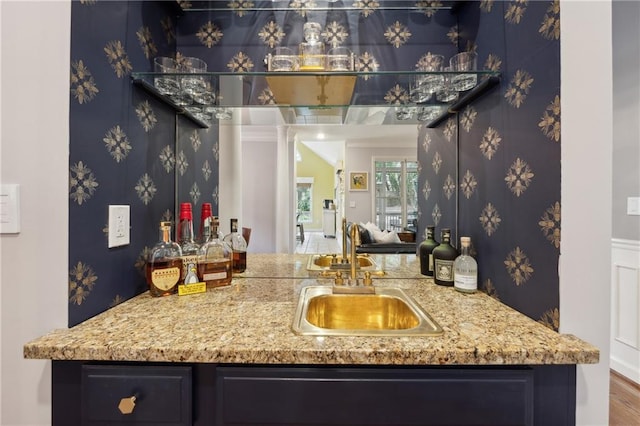 bar with light stone counters and sink