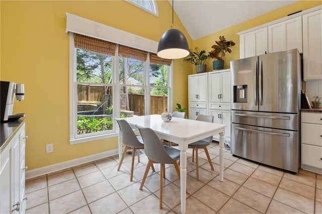 tiled dining space with high vaulted ceiling