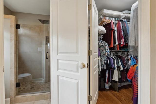 bathroom with hardwood / wood-style floors and a shower with door