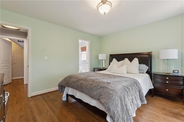 bedroom featuring hardwood / wood-style floors and ensuite bath