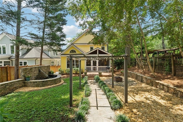 exterior space featuring a porch and an outdoor fire pit