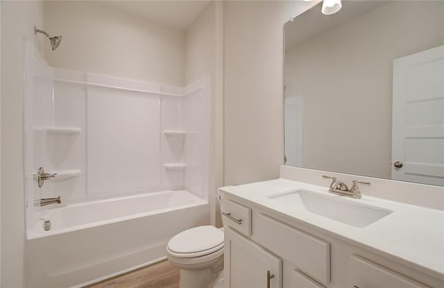 bathroom featuring vanity, shower / bathing tub combination, toilet, and wood finished floors