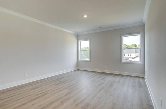 unfurnished room featuring light wood-style floors, baseboards, and ornamental molding