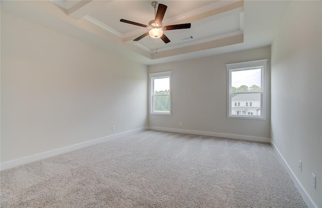 empty room featuring ornamental molding, a tray ceiling, baseboards, light colored carpet, and ceiling fan