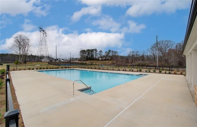 pool featuring a patio and fence