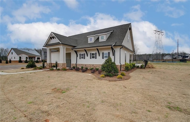 view of front of property with fence and roof with shingles