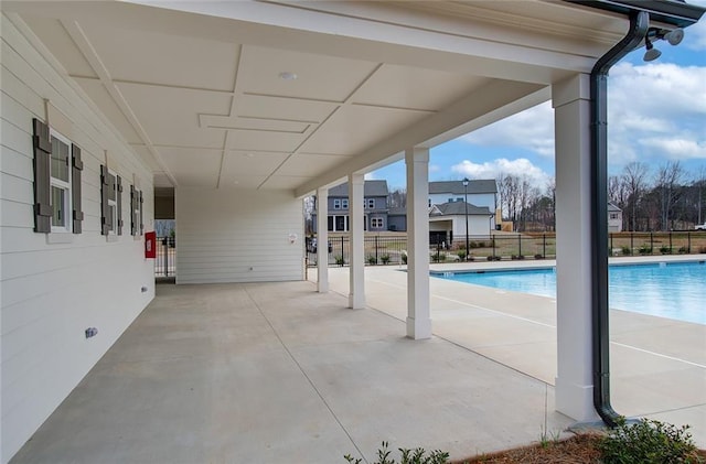 view of patio / terrace with a community pool and fence