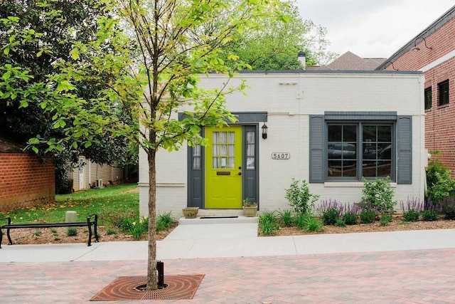 view of exterior entry featuring brick siding