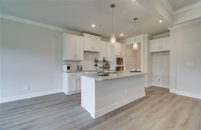 kitchen featuring light wood finished floors, baseboards, ornamental molding, and white cabinetry