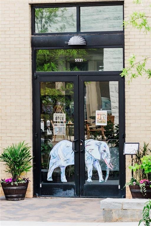 doorway to property with brick siding