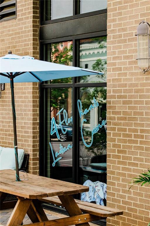 property entrance featuring brick siding and outdoor dining space