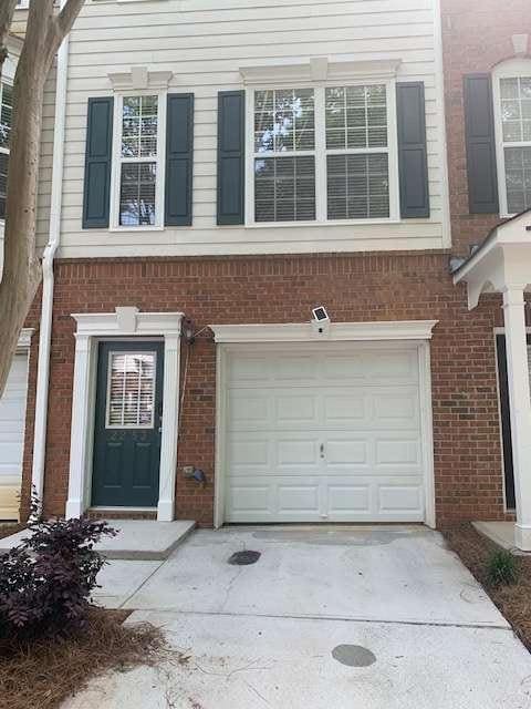 2253 Dillard Xing, Tucker, GA 30084 - view of side of property featuring brick siding and an attached garage