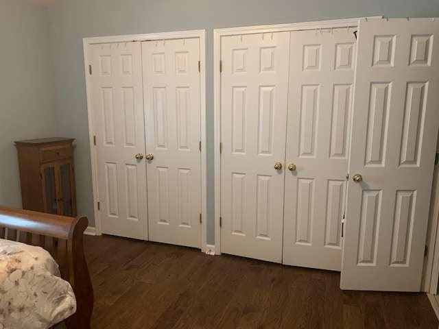 2253 Dillard Xing, Tucker, GA 30084 - bedroom featuring two closets and dark wood-style flooring
