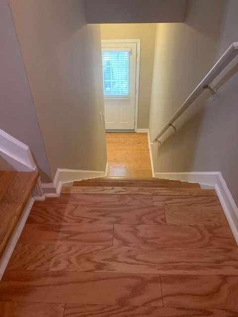 2253 Dillard Xing, Tucker, GA 30084 - staircase with baseboards and wood finished floors