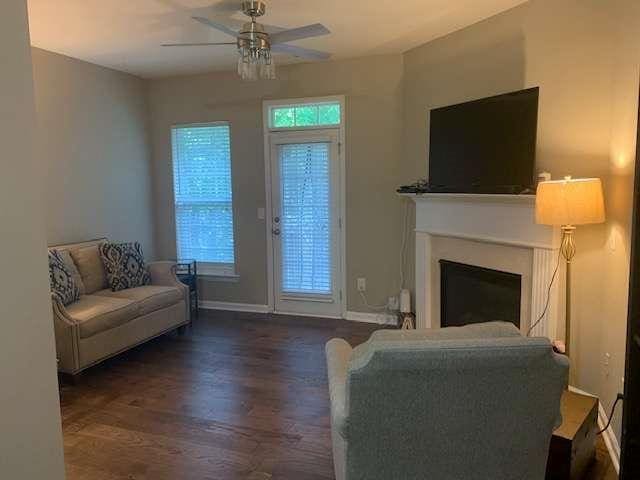 2253 Dillard Xing, Tucker, GA 30084 - living area featuring baseboards, dark wood-style flooring, a ceiling fan, and a fireplace