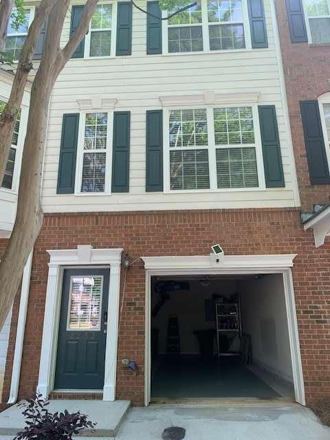 2253 Dillard Xing, Tucker, GA 30084 - view of side of property featuring brick siding and an attached garage