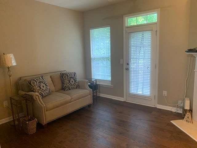 2253 Dillard Xing, Tucker, GA 30084 - living area with baseboards, wood finished floors, and a wealth of natural light