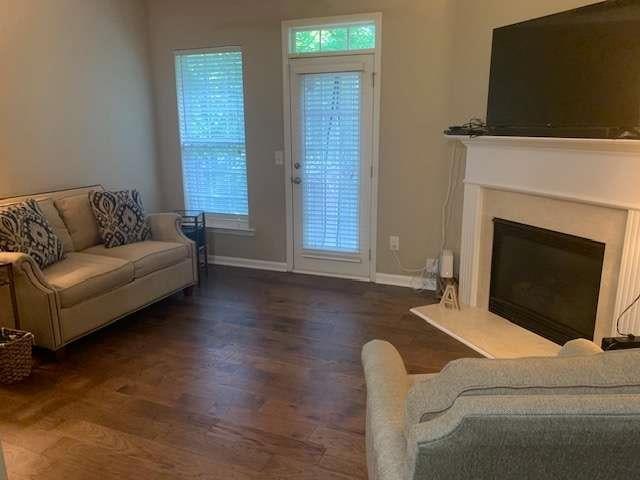 2253 Dillard Xing, Tucker, GA 30084 - living area featuring baseboards, wood finished floors, and a glass covered fireplace