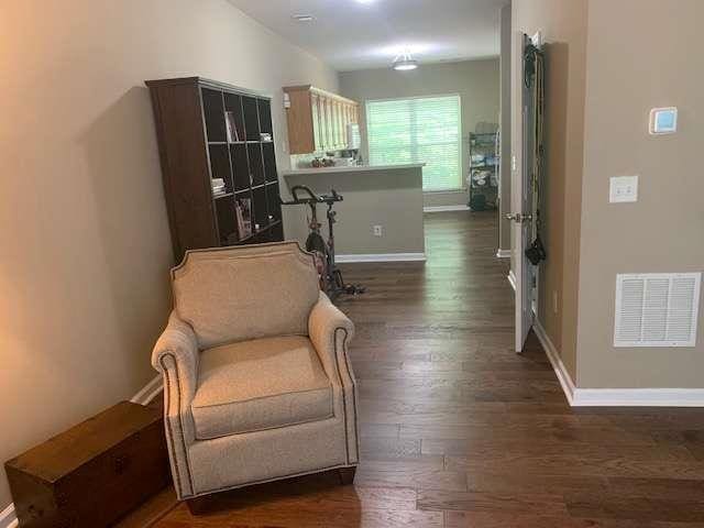 2253 Dillard Xing, Tucker, GA 30084 - living area featuring baseboards, wood finished floors, and visible vents