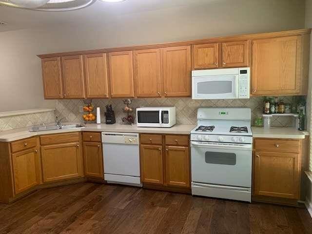 2253 Dillard Xing, Tucker, GA 30084 - kitchen with light countertops, white appliances, and backsplash