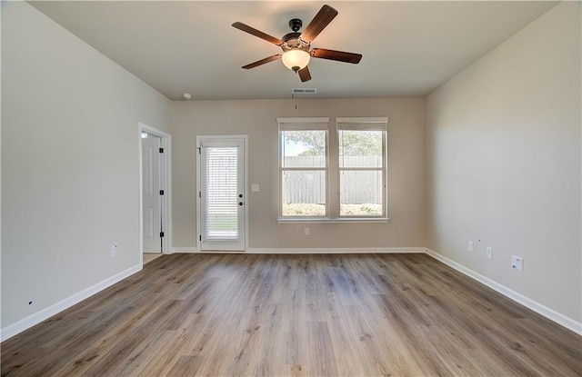 unfurnished room with ceiling fan and light wood-type flooring