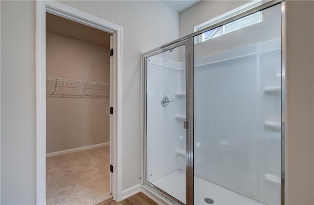 bathroom with a shower with door