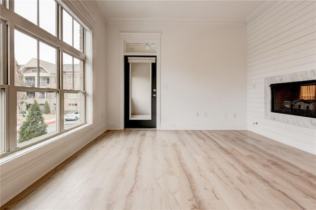 625 Piedmont Ave NE Unit 2004, Atlanta, GA 30308 - unfurnished living room with ornamental molding, a fireplace, wood finished floors, and baseboards