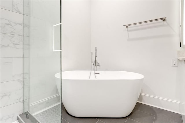 625 Piedmont Ave NE Unit 2004, Atlanta, GA 30308 - bathroom with a freestanding bath, a shower stall, tile patterned flooring, and baseboards