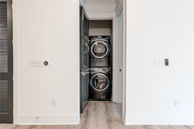 625 Piedmont Ave NE Unit 2004, Atlanta, GA 30308 - washroom with stacked washing machine and dryer, wood finished floors, and baseboards
