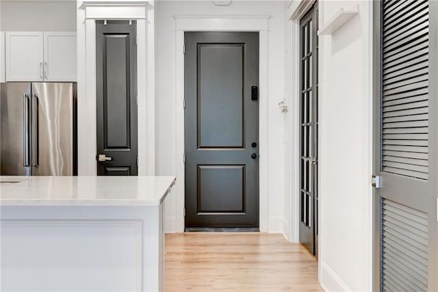 625 Piedmont Ave NE Unit 2004, Atlanta, GA 30308 - kitchen featuring high end fridge, light wood-style floors, light countertops, and white cabinets