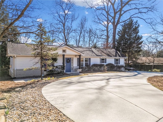 single story home featuring concrete driveway and brick siding